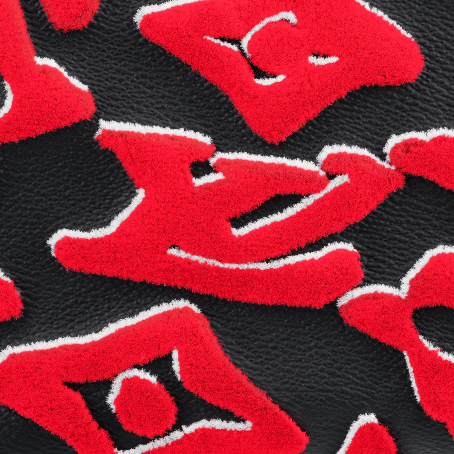 Close-up of red and black patterned fabric with abstract shapes