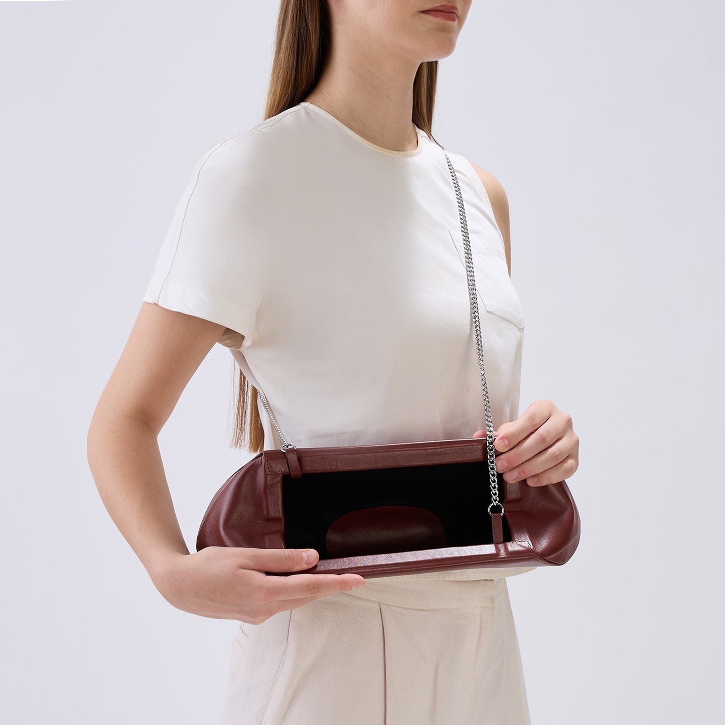 Bag It Elizabeth brick red baguette clutch worn on the shoulder, alternate angle