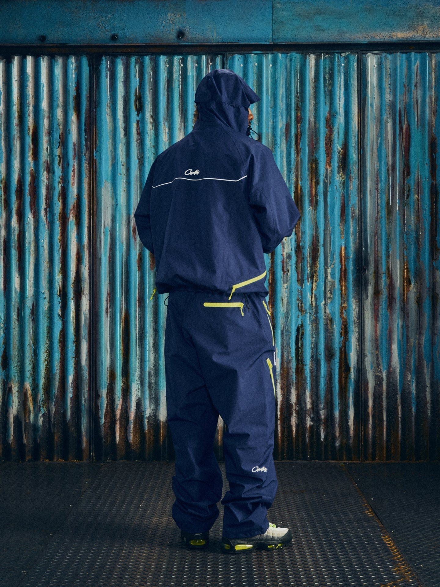 Corteiz Blue Nylon Elitework Apex Shell Jacket, Navy, side view showing overall silhouette