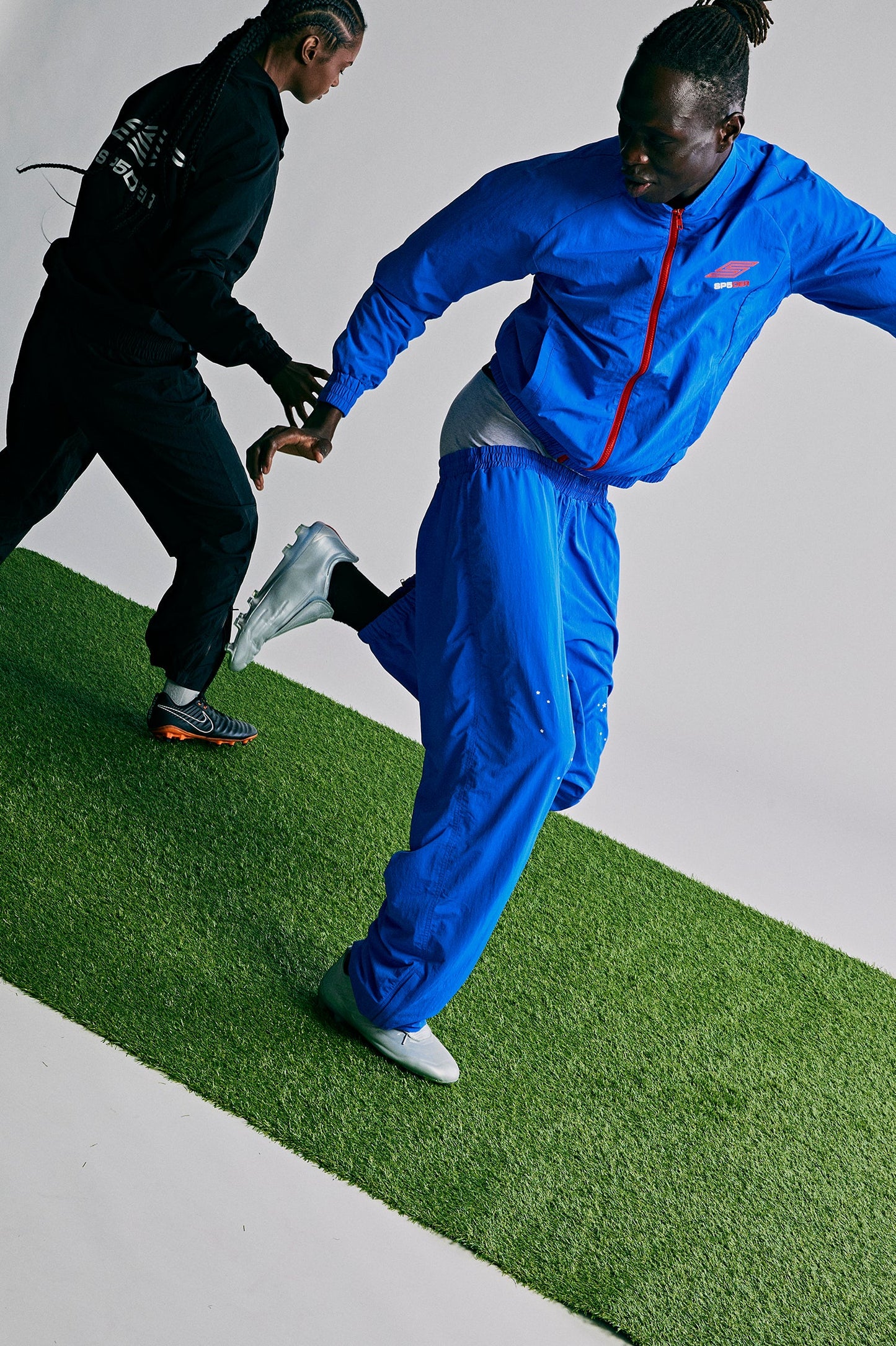 Model wearing SP5DER Pro Windbreaker in Blue additional angle
