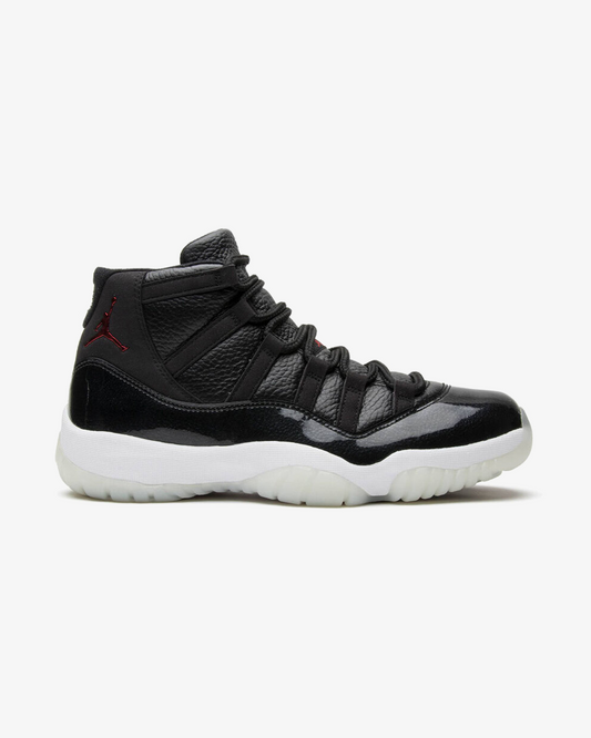 Air Jordan 11 Retro 72-10 sneaker, front view showing black and white patent leather upper
