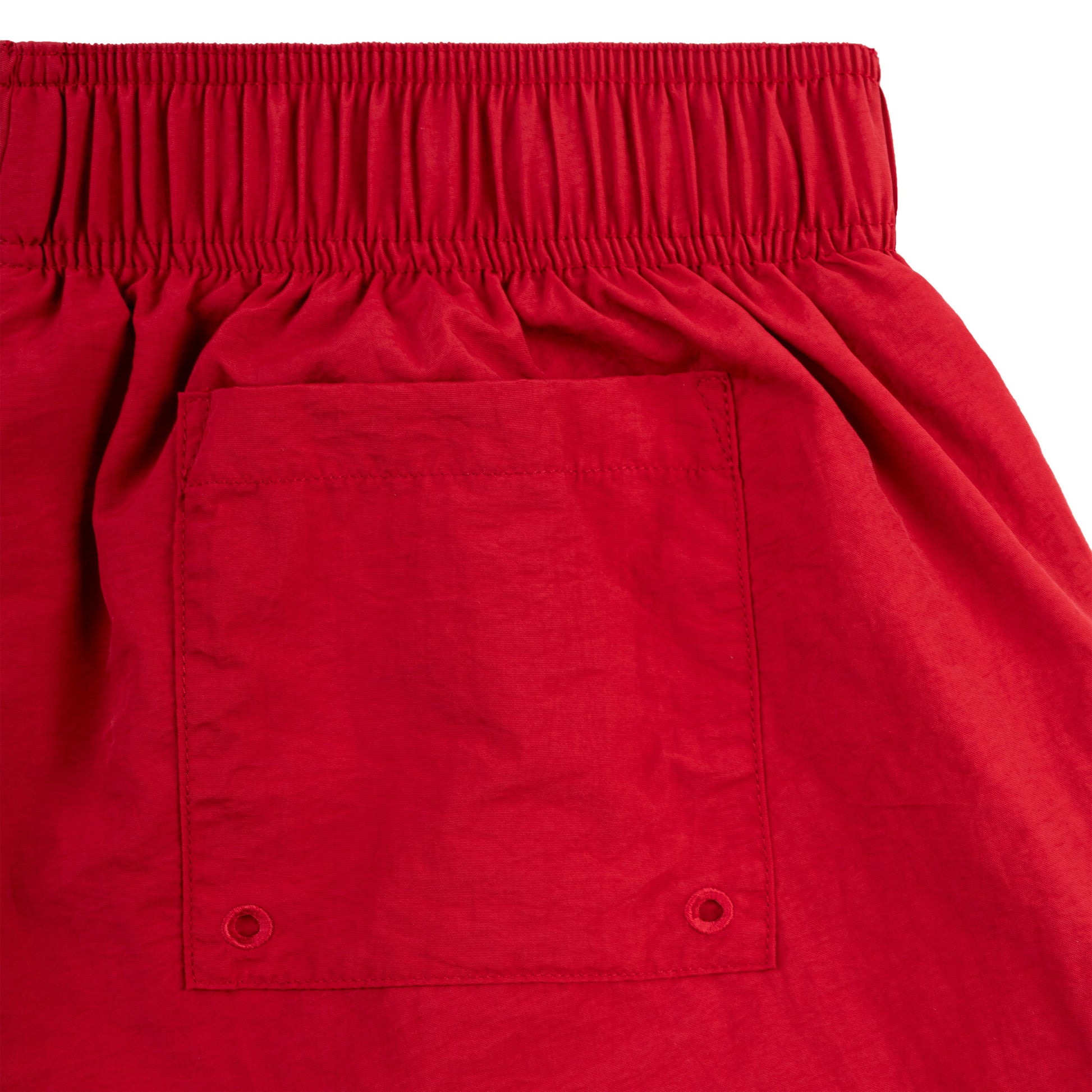 Detail view of drawstring waistband on SP5DER short in Red