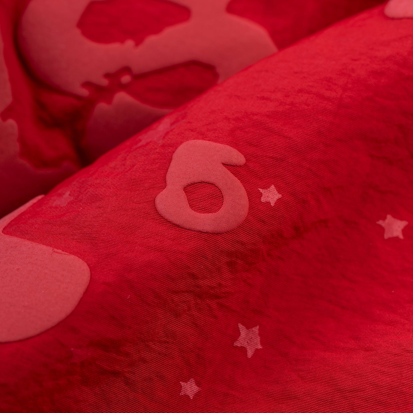Detail view of Beluga puff print on SP5DER short in Red
