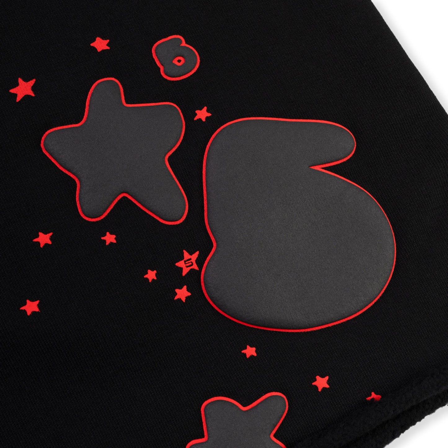 Detail view of drawcord waistband on SP5DER sweatshort in Black