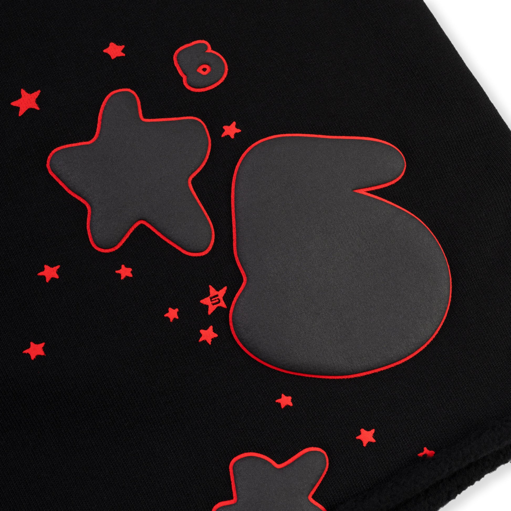 Detail view of drawcord waistband on SP5DER sweatshort in Black