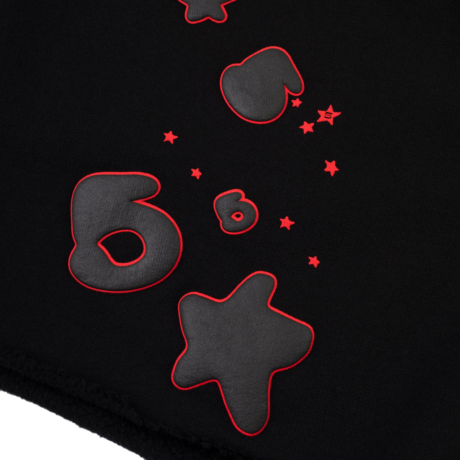Detail view of fleece texture on SP5DER sweatshort in Black