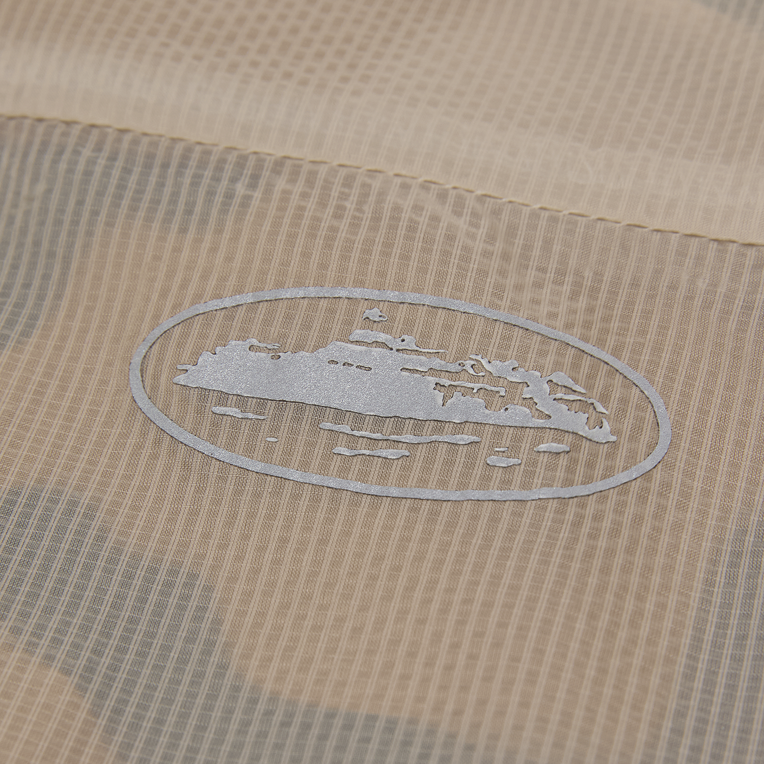 Corteiz Brown Nylon Dual-Layer Litework Jacket, Desert Camo, close-up of raglan sleeve construction