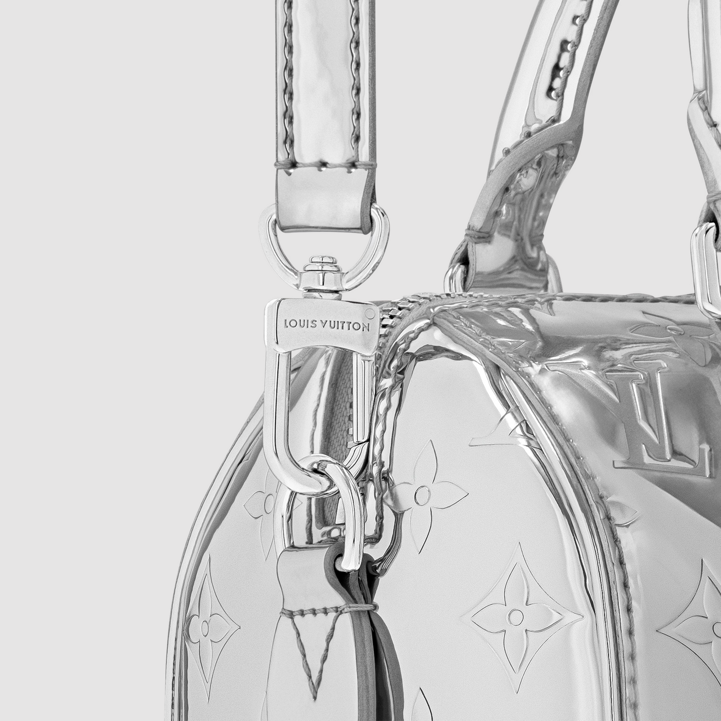 Close-up of a Louis Vuitton handbag with a silver chain and hardware.