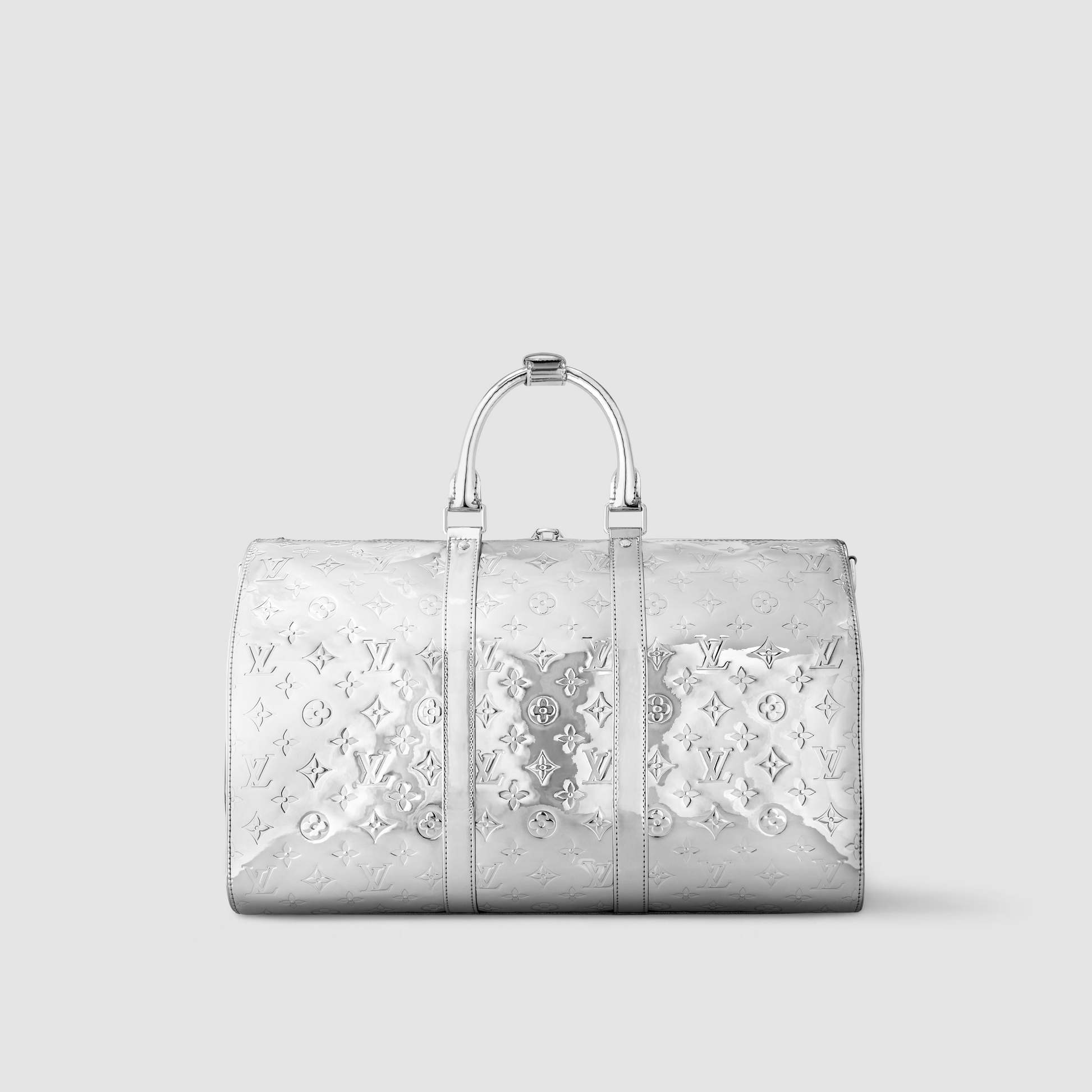 Silver handbag with intricate patterns on a light gray background