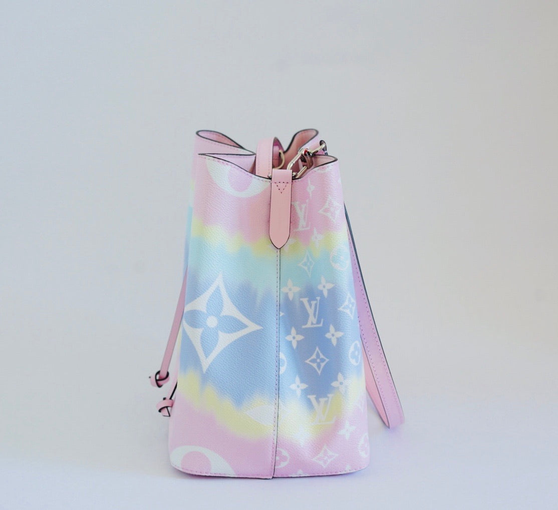Colorful bucket bag with a brand logo on a light gray background