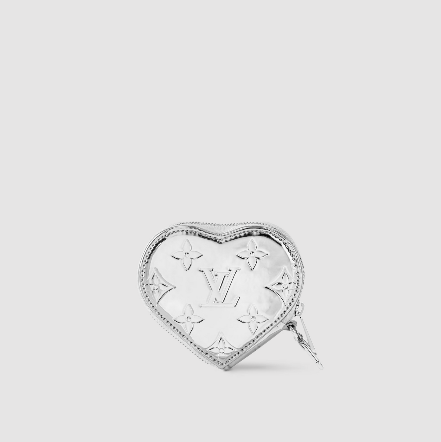 Heart-shaped silver brooch with brand logo on a light gray background
