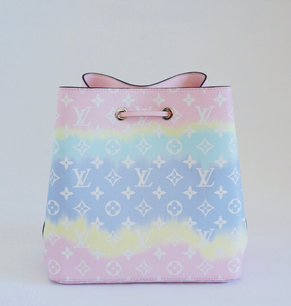 Pastel gradient handbag with a brand logo on a white background
