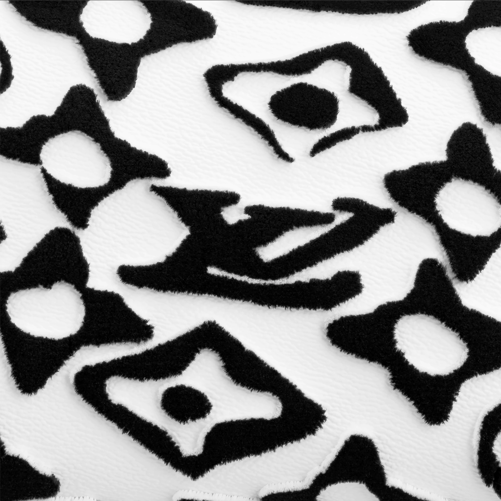 Black and white pattern with star and bow shapes on a textured background