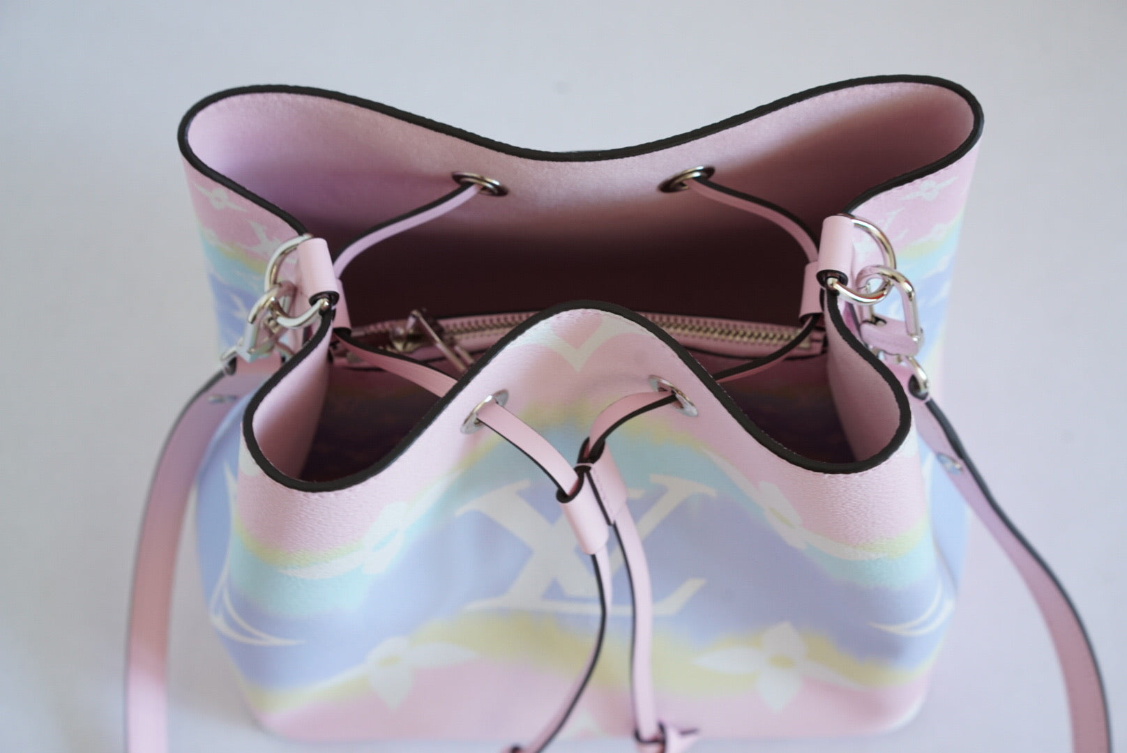 Pastel-colored handbag with a clear base on a white background