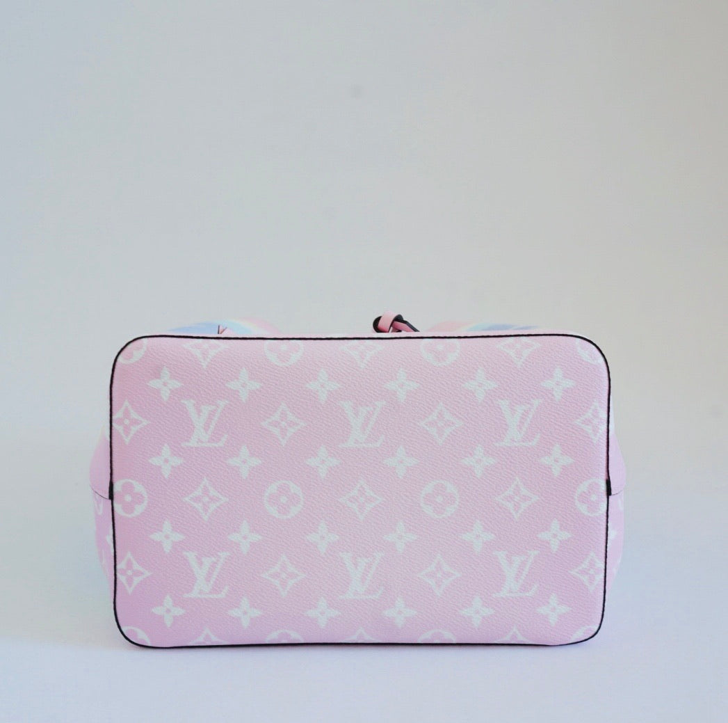 Pink pouch with white monogram pattern on a light gray background