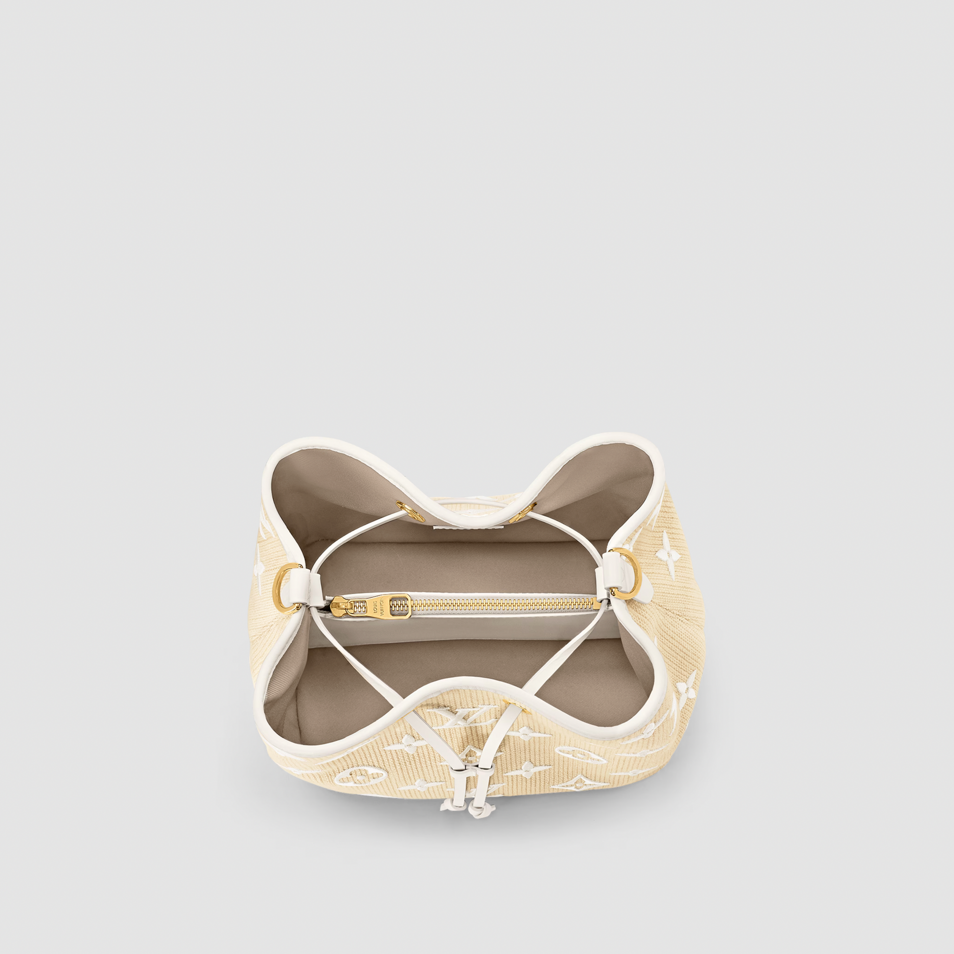 Beige bra with gold accents on a light gray background