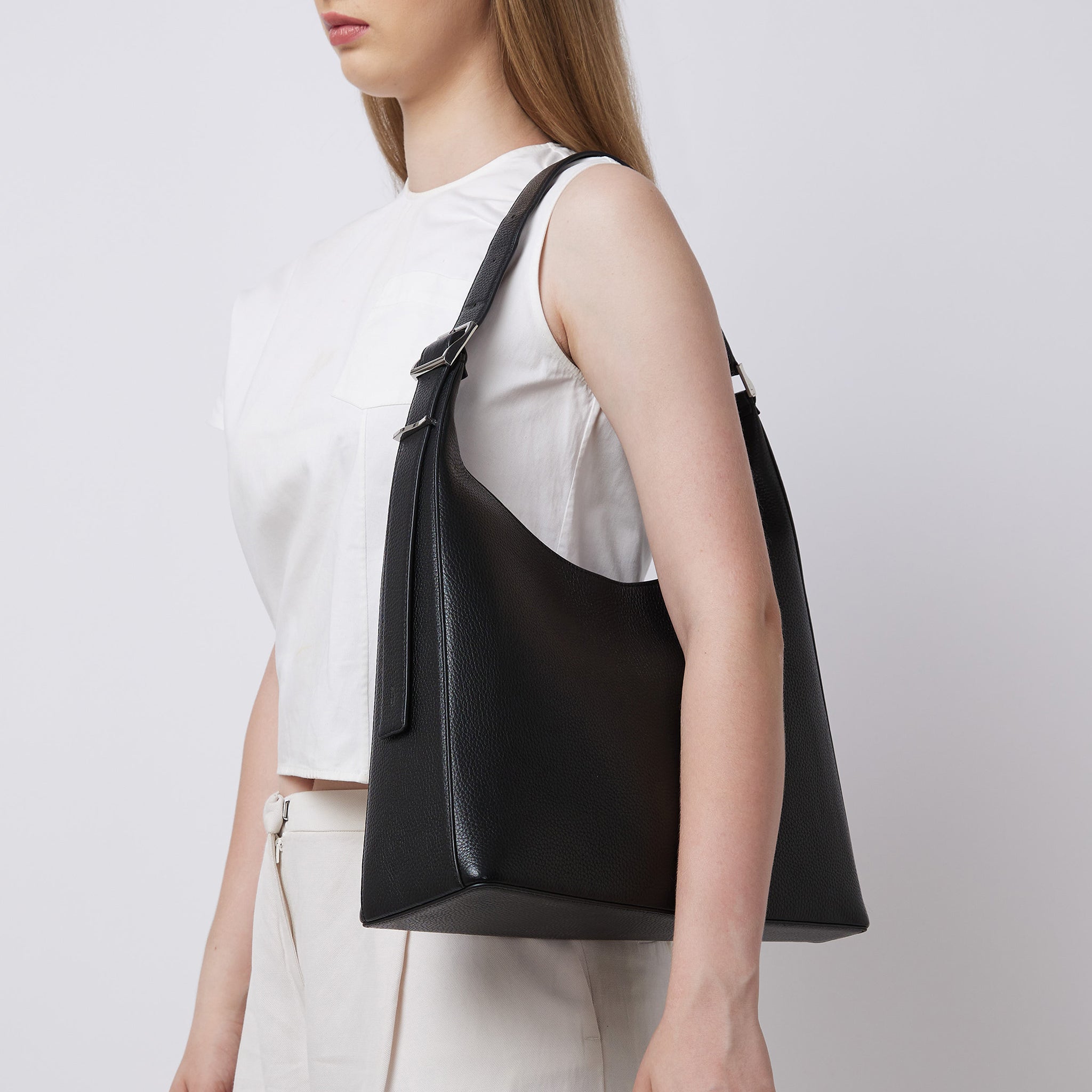 Bag It Danny Flatiron black leather shoulder bag worn on the shoulder
