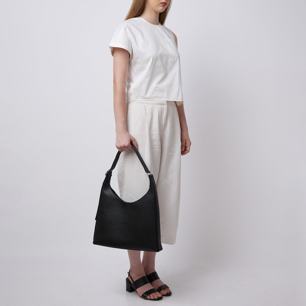 Bag It Danny Flatiron black pebble leather shoulder bag carried by hand