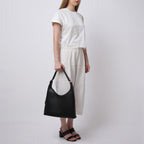 Bag It Danny Flatiron black pebble leather shoulder bag carried by hand