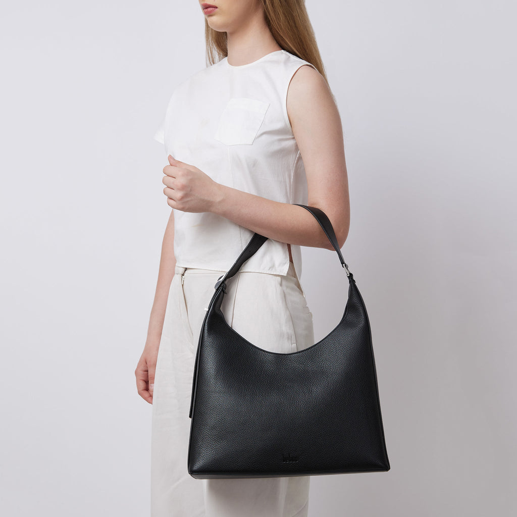 Bag It Danny Flatiron black leather shoulder bag worn on the arm
