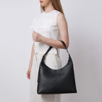 Bag It Danny Flatiron black leather shoulder bag worn on the arm