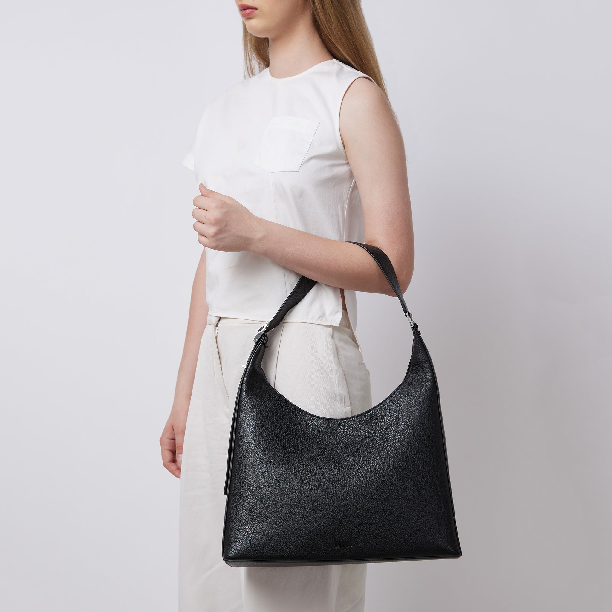 Bag It Danny Flatiron black leather shoulder bag worn on the arm
