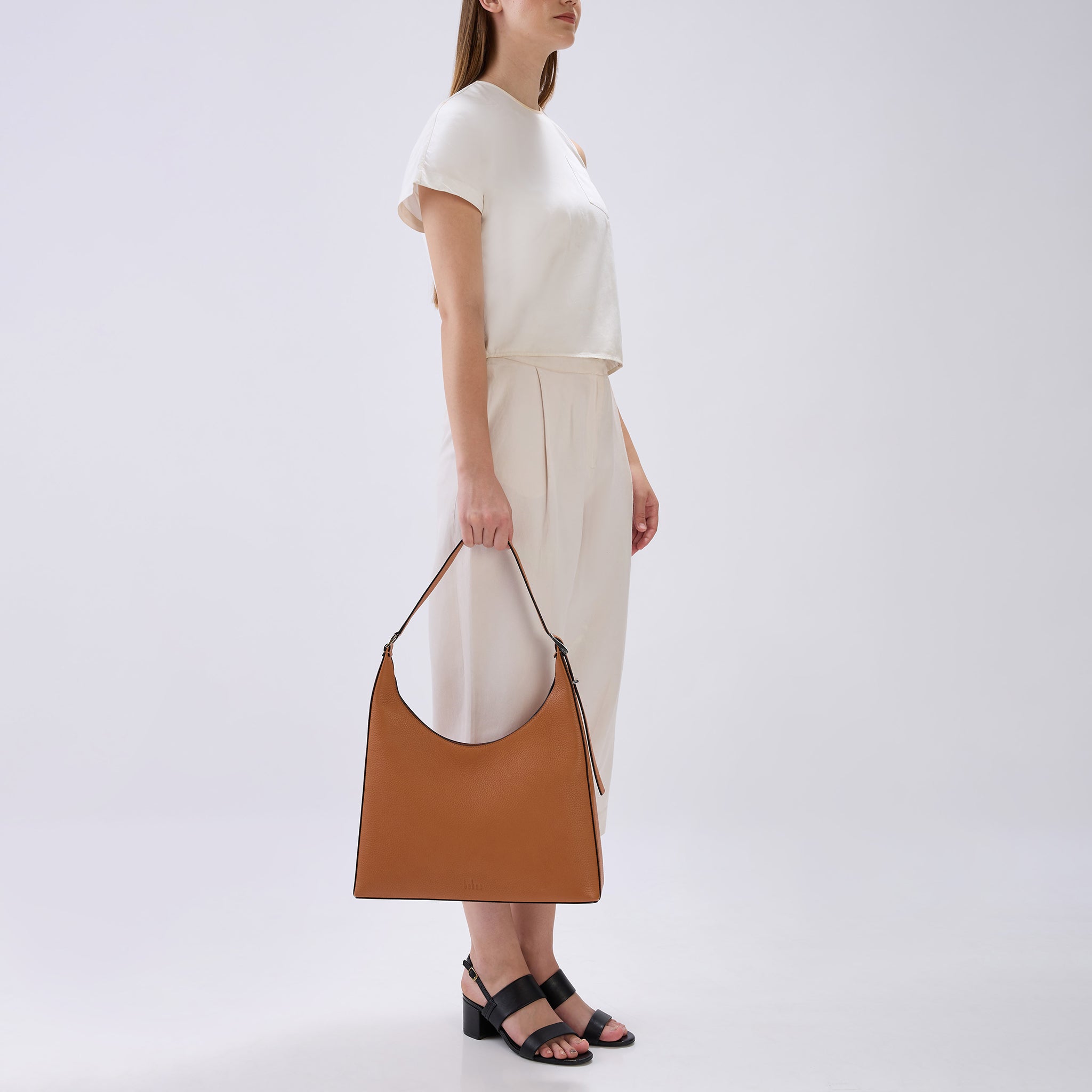 Bag It Danny Flatiron clay pebble leather shoulder bag carried by hand