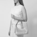 Bag It Danny Flatiron ocean blue leather shoulder bag worn on the arm