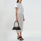 Bag It Diana black leather shoulder bag carried by hand