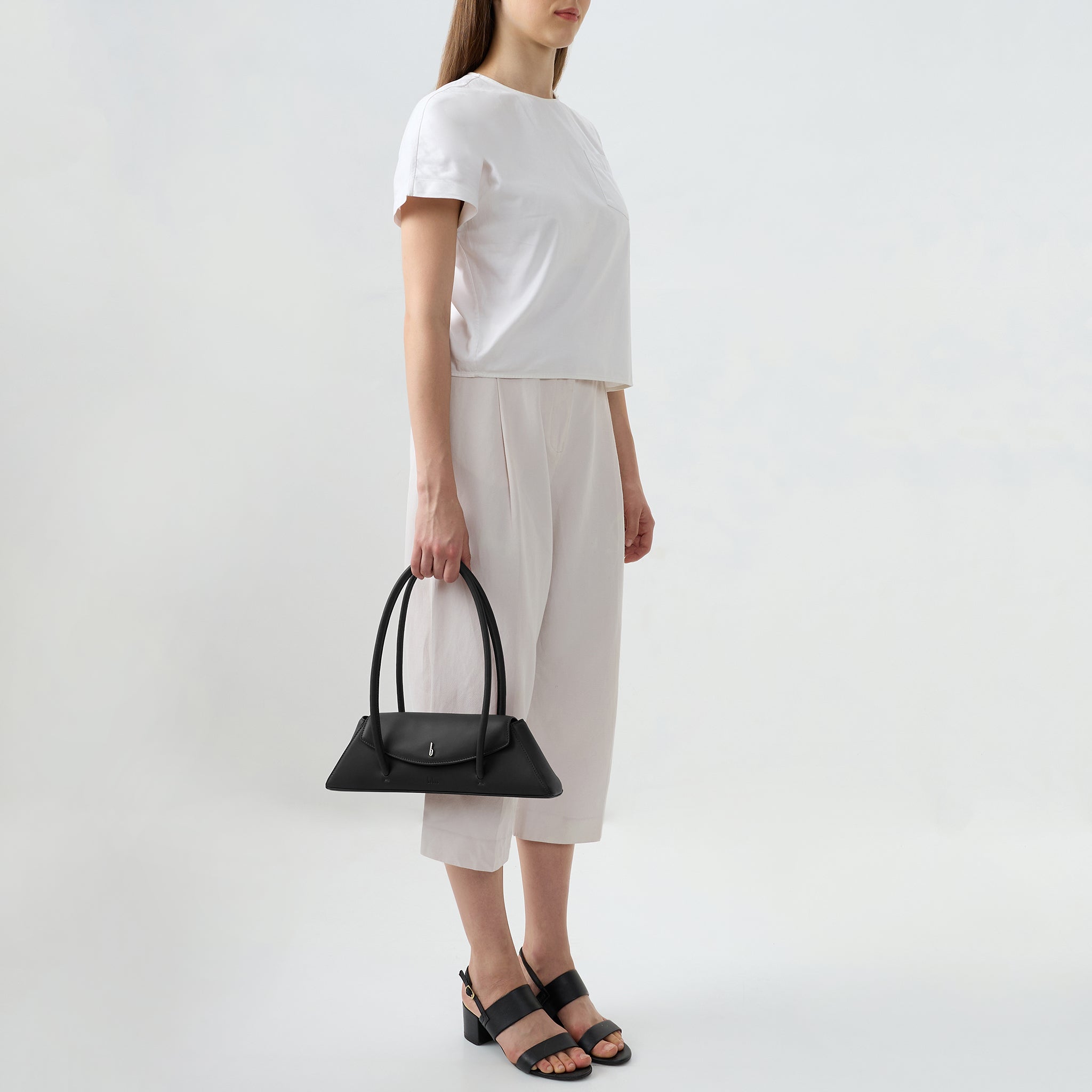 Bag It Diana black leather shoulder bag carried by hand