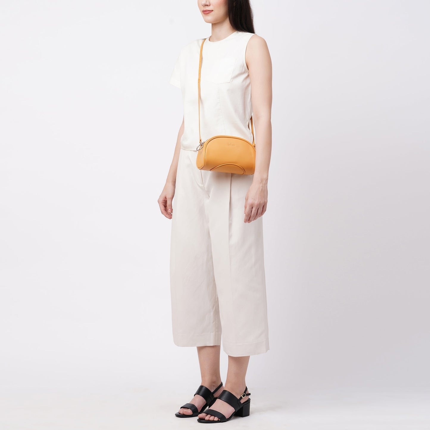 Bag It Elizabeth maize camera crossbody bag worn crossbody, front angle