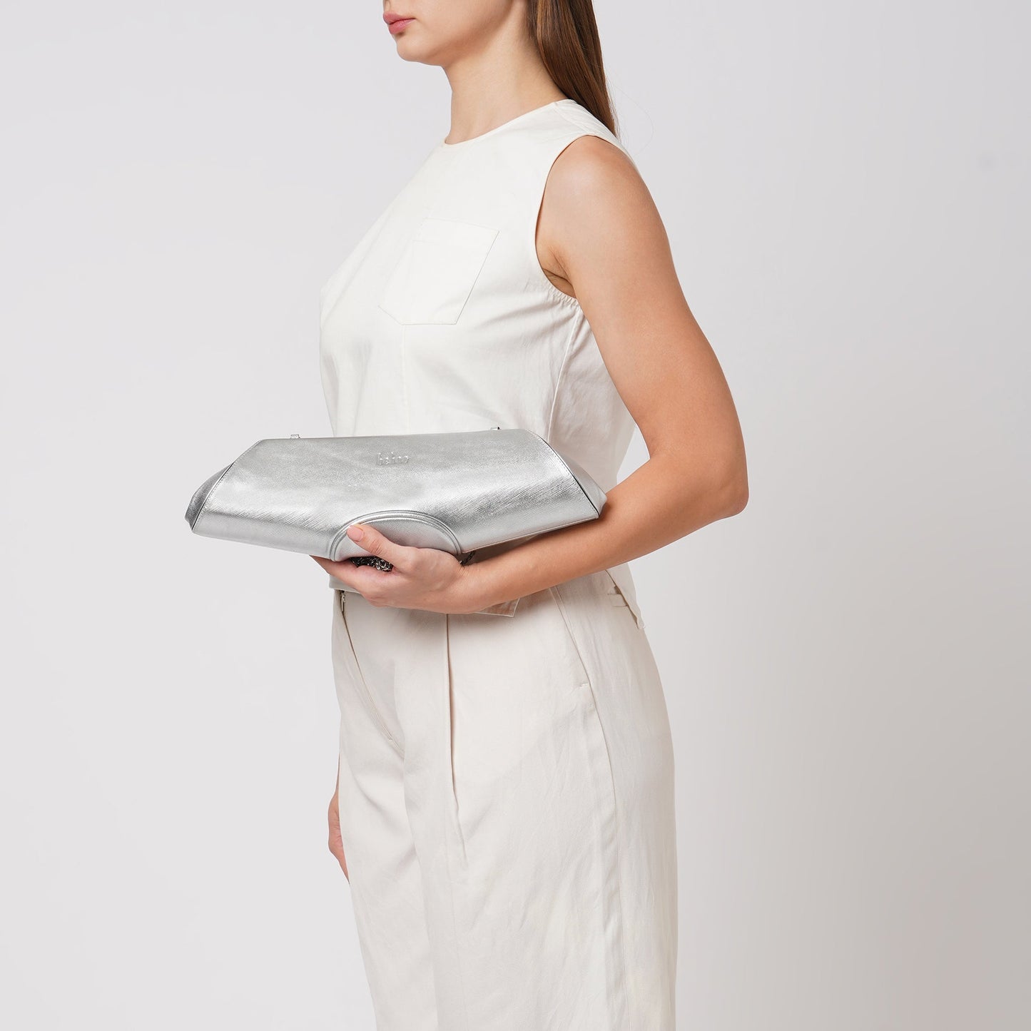 Bag It Elizabeth metallic silver baguette clutch worn on the arm