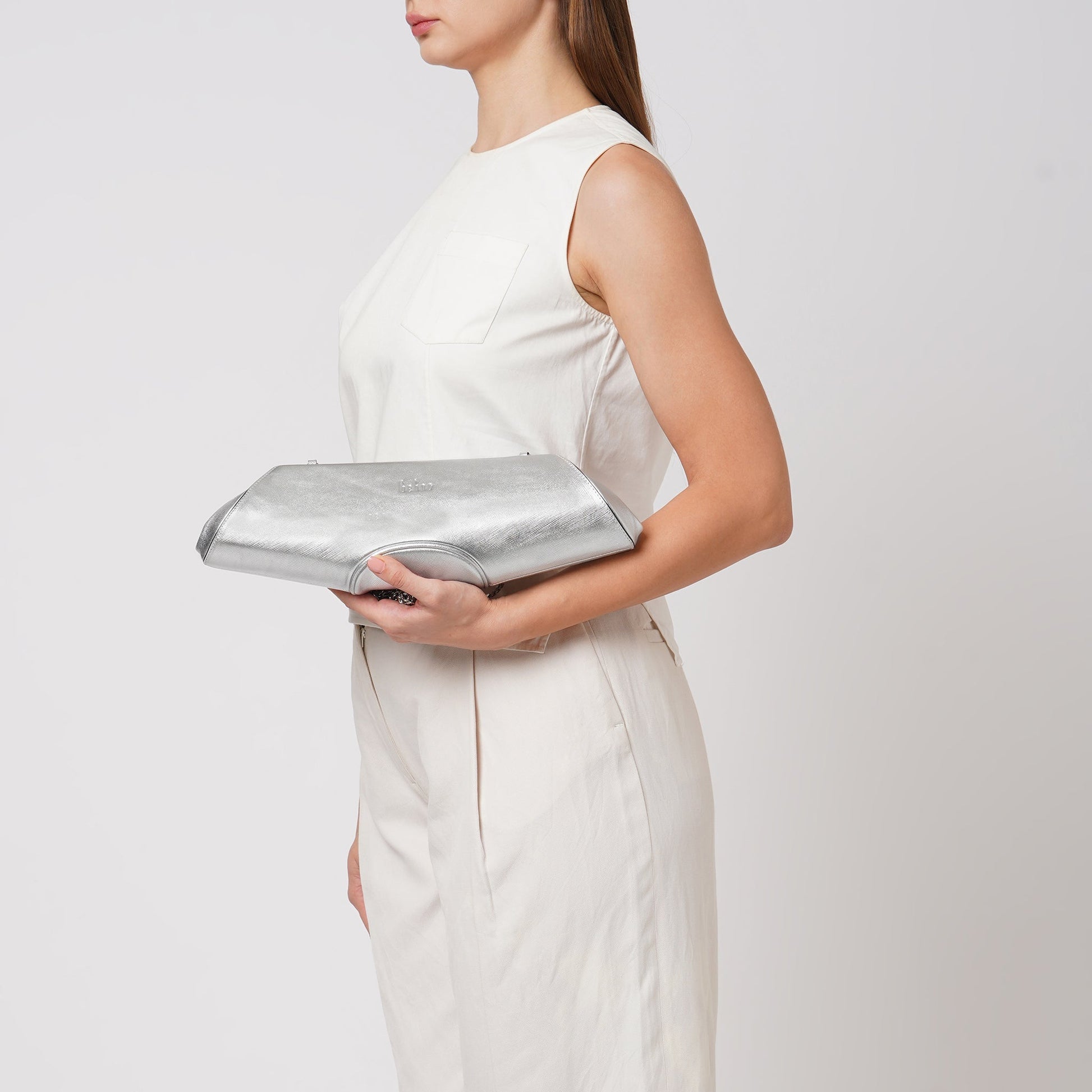 Bag It Elizabeth metallic silver baguette clutch worn on the arm
