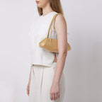 Bag It Elizabeth mini bisque baguette bag worn on the shoulder