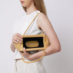 Bag It Elizabeth mini bisque pebble leather baguette bag worn on the shoulder, alternate angle