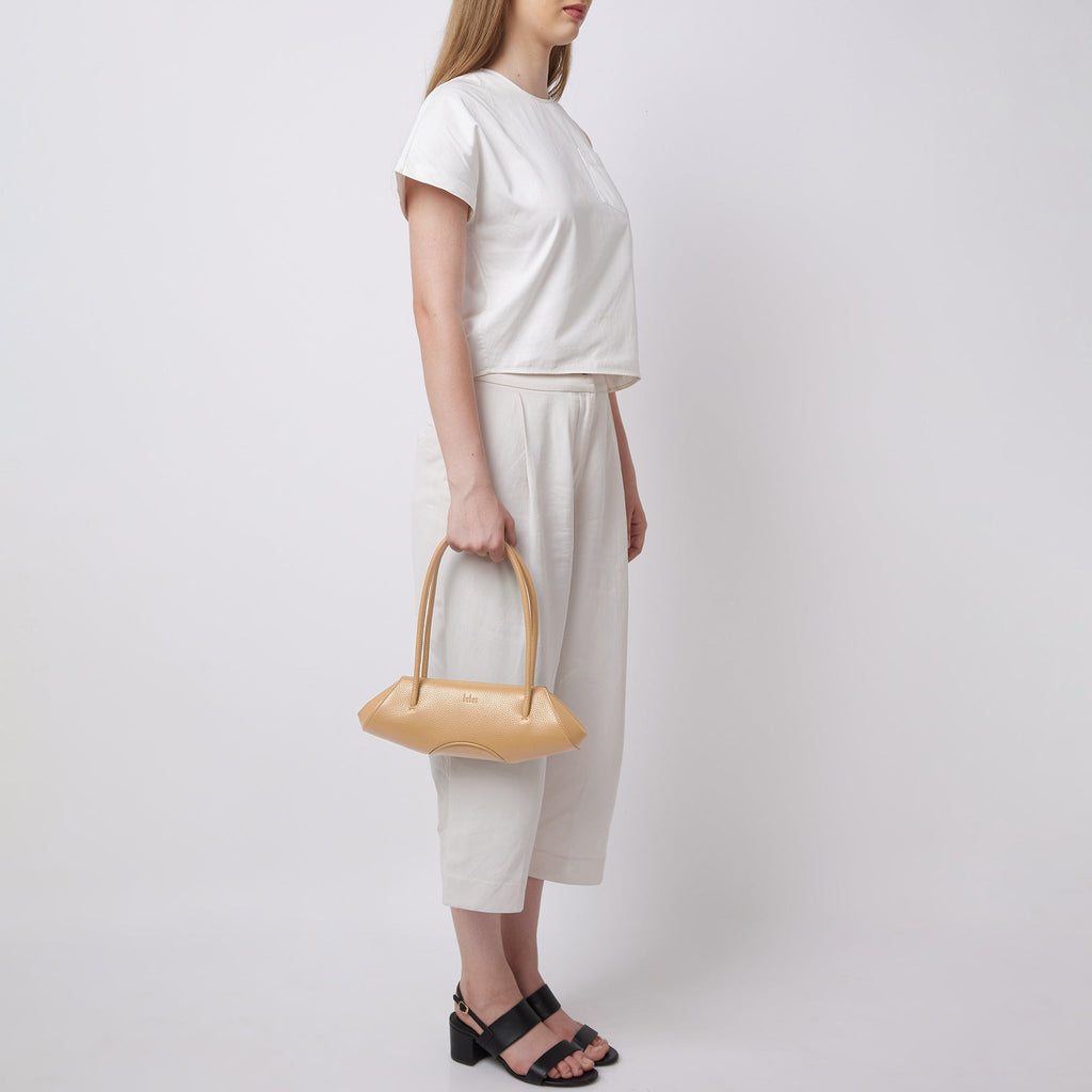 Bag It Elizabeth mini bisque baguette bag carried by hand