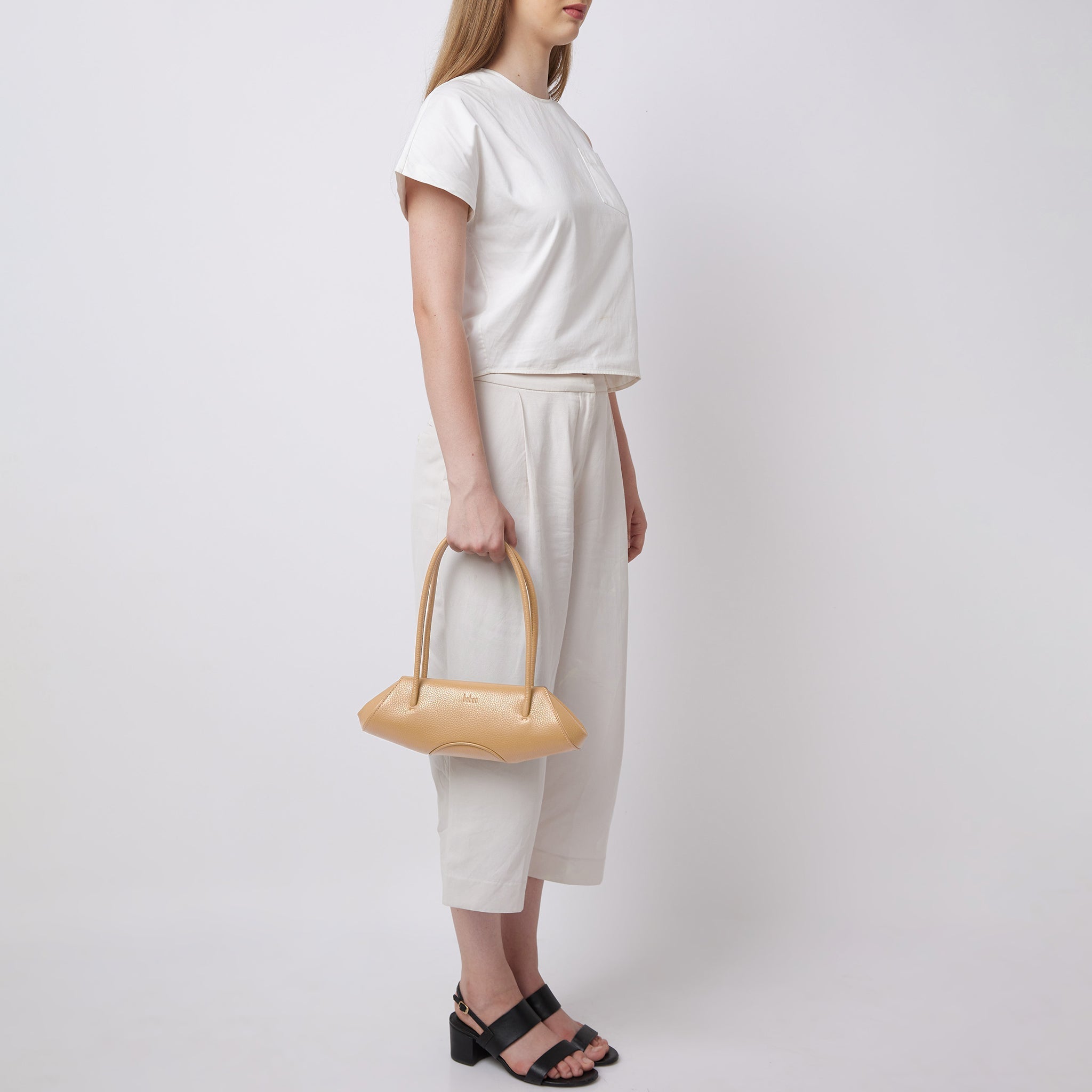 Bag It Elizabeth mini bisque baguette bag carried by hand