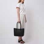 Bag It Elizabeth black leather tote bag carried by hand