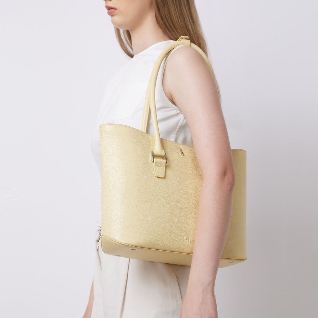 Bag It Elizabeth buttercream pebble leather tote bag worn on the shoulder