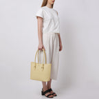 Bag It Elizabeth buttercream leather tote bag carried by hand