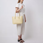 Bag It Elizabeth buttercream pebble leather tote bag worn on the arm