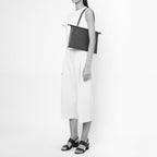 Bag It Frida almond leather tote bag worn on the shoulder