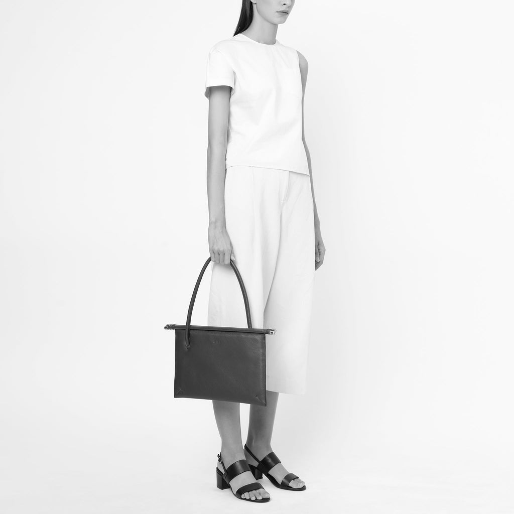 Bag It Frida almond pebble leather tote bag carried by hand