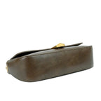 Brown leather clutch bag with gold accents on a white background
