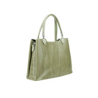 Green handbag with textured surface on a white background