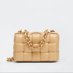 Beige handbag with a gold chain on a light gray background