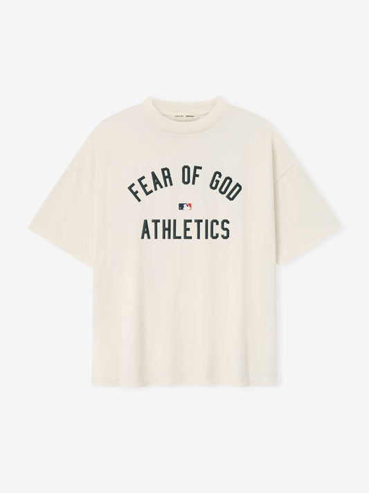 Beige t-shirt with 'Fear of God Athletics' text on a white background