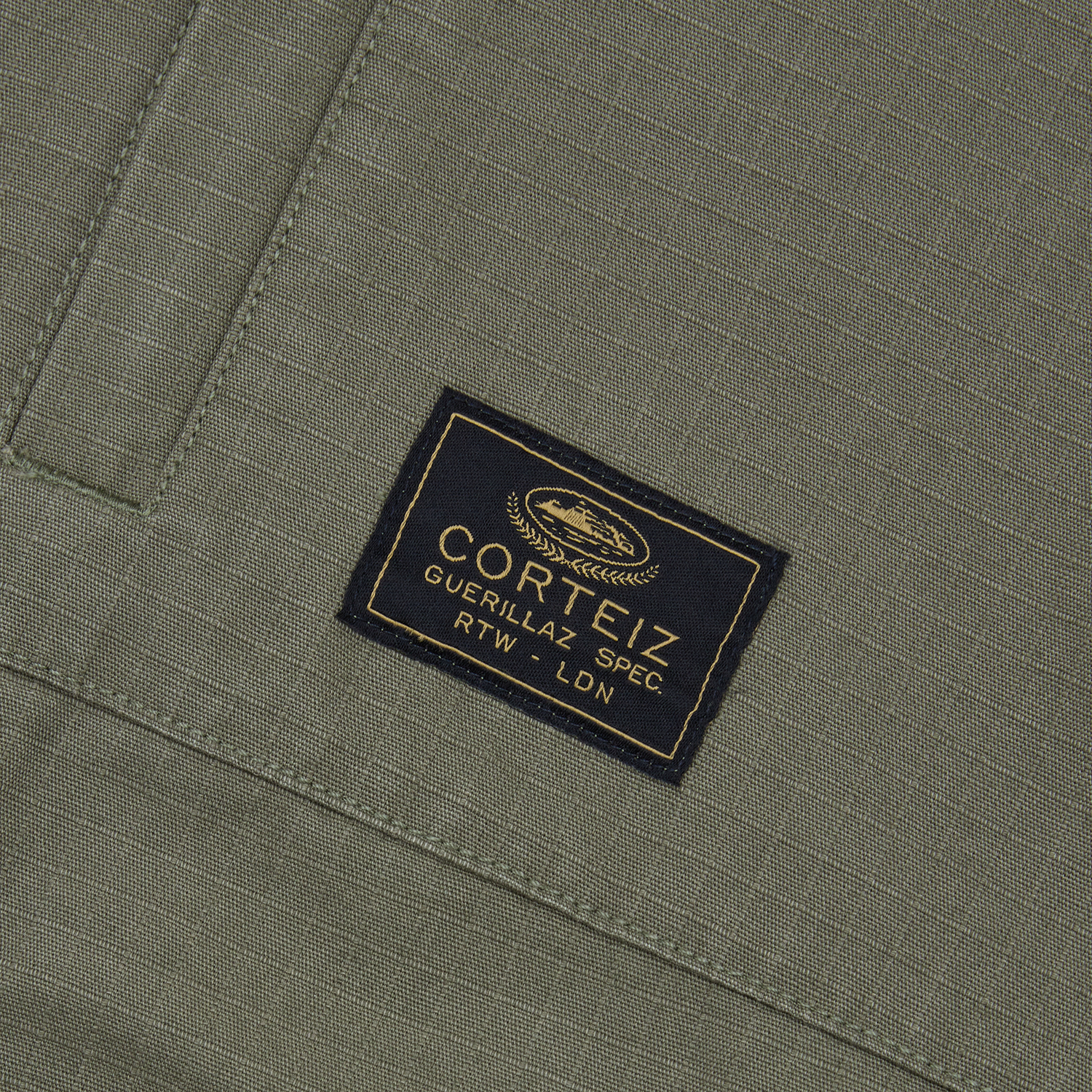 Corteiz Green Cotton Ripstop Guerillaz Jacket, Olive, close-up of chest pocket detail