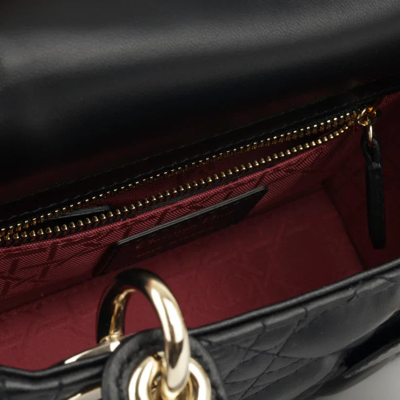 Detail view of Dior charm hardware on Lady Dior Small Bag in Black Lambskin