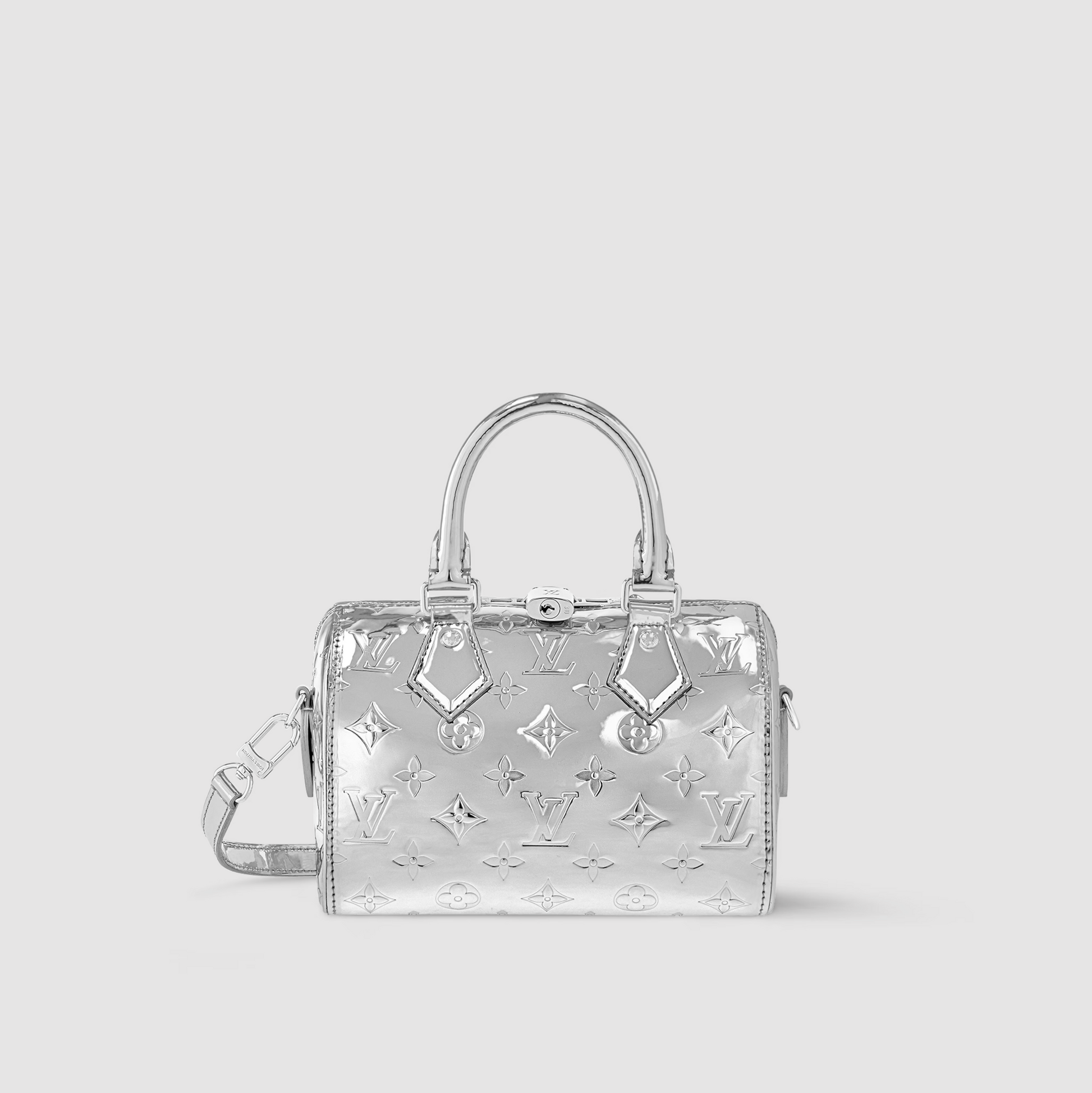 Silver handbag with reflective monogram pattern on a light gray background